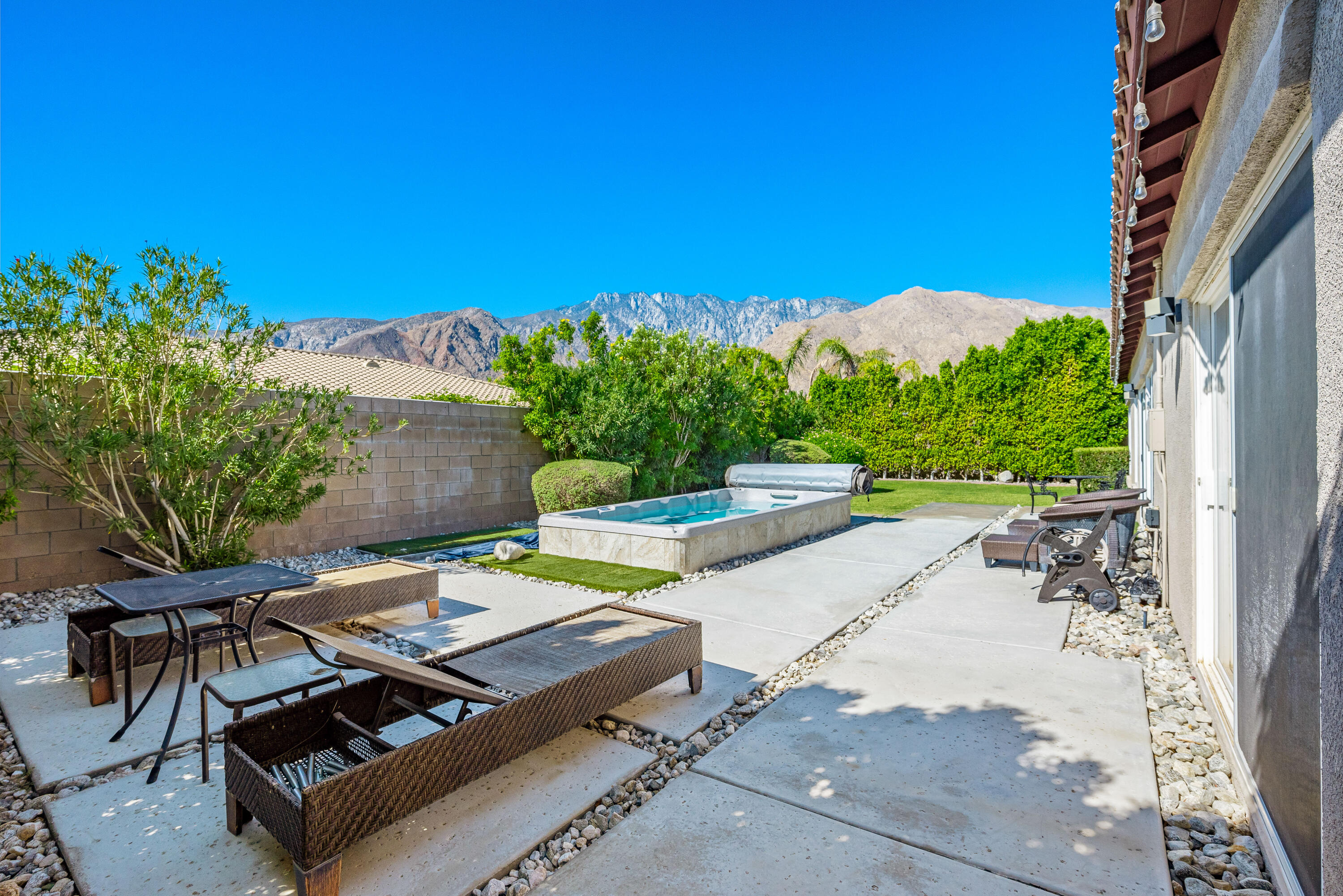 985 Alta Ridge Palm Springs, CA 92262 - Photo 23 of 44 a view of a patio with table and chairs with wooden floor and fence