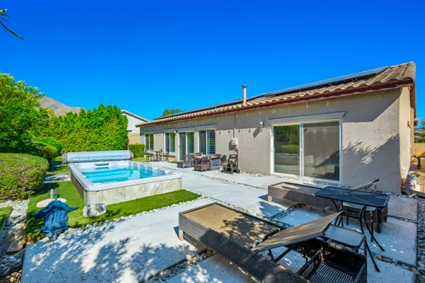 a view of a backyard with sitting area