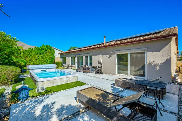 a view of a backyard with sitting area
