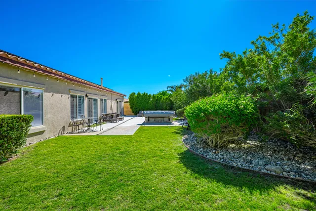 a view of a house with backyard porch and sitting area