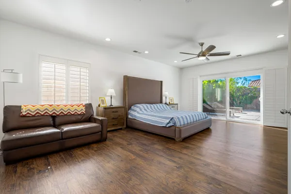 a bedroom with a bed couch and window