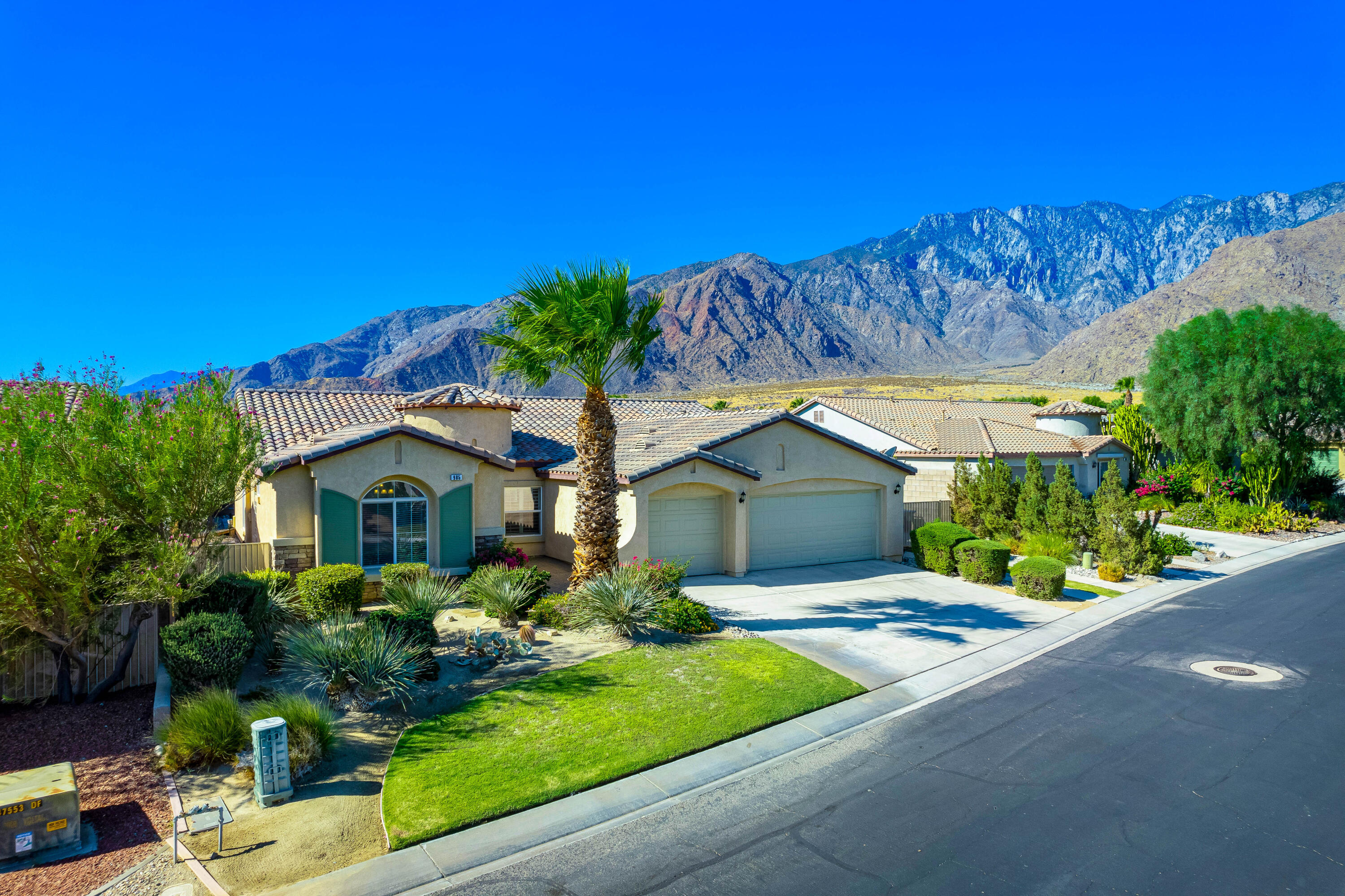985 Alta Ridge Palm Springs, CA 92262 - Photo 3 of 44 a front view of a house with a yard and potted plants