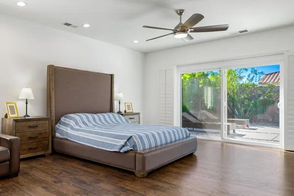 a bedroom with a large bed and a large window