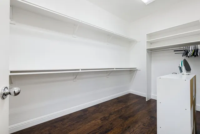 a view of storage and utility room with wooden floor