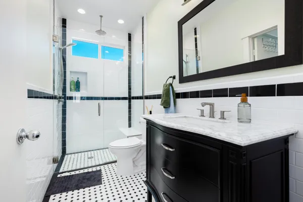 a bathroom with a sink a toilet and a mirror