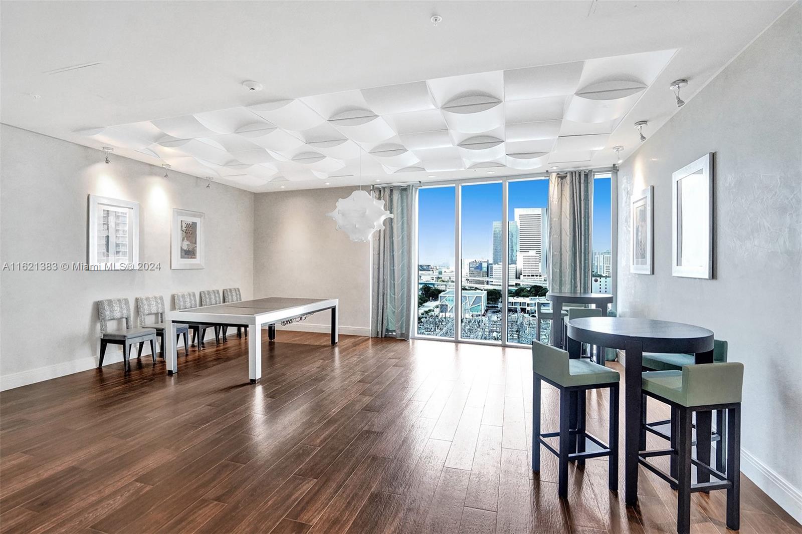 185 Southwest 7th Street, Unit 3408 Miami, FL 33130 - Photo 13 of 14 a view of a dining room with furniture and wooden floor