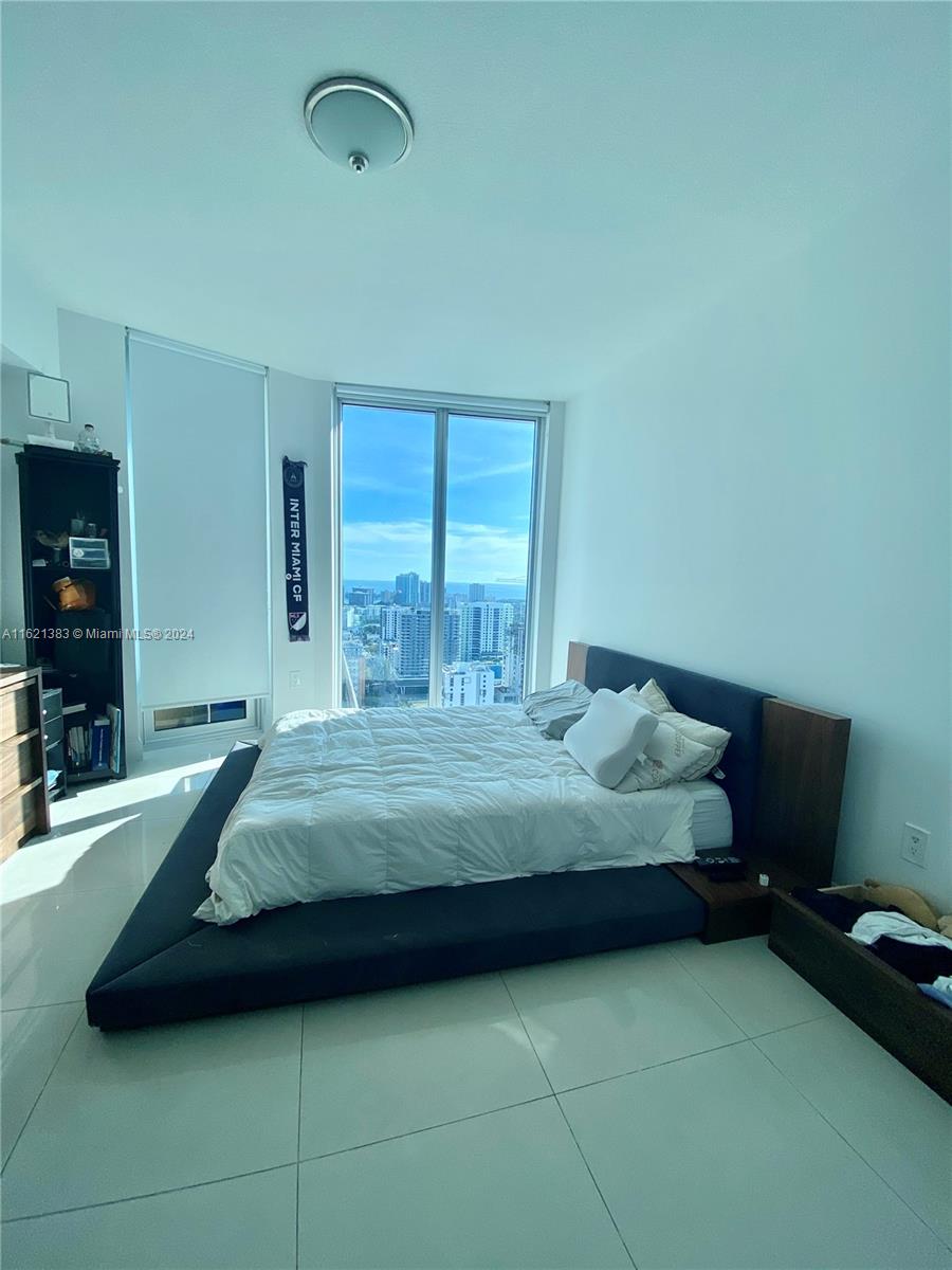 185 Southwest 7th Street, Unit 3408 Miami, FL 33130 - Photo 3 of 14 a bedroom with a bed and a flat screen tv