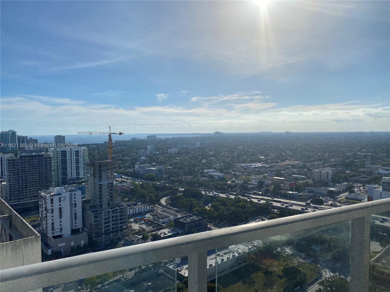 185 Southwest 7th Street, Unit 3408 Miami, FL 33130 - Photo 6 of 14 a view of a city from a balcony