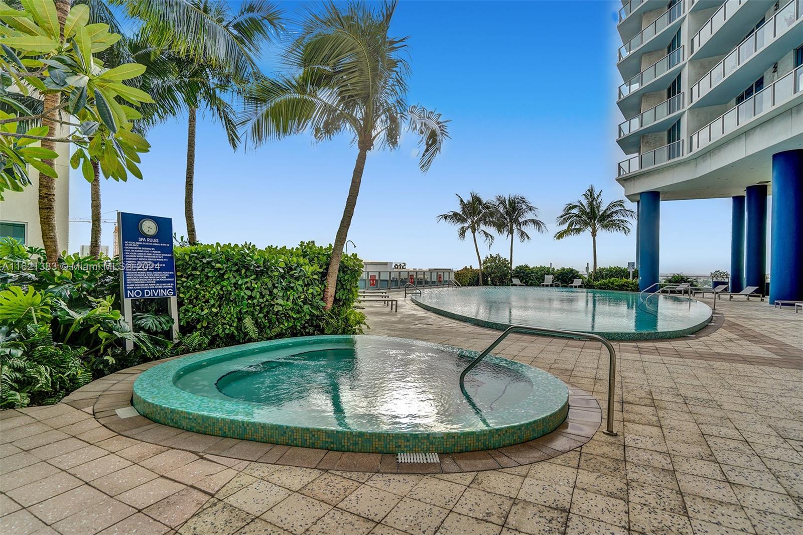 185 Southwest 7th Street, Unit 3408 Miami, FL 33130 - Photo 8 of 14 a view of a swimming pool with a yard