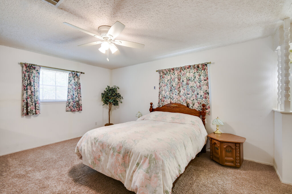 301 Navajo Trail Georgetown, TX 78633 - Photo 28 of 35 Bedroom featuring light colored carpet, ceiling fan, and a textured ceiling