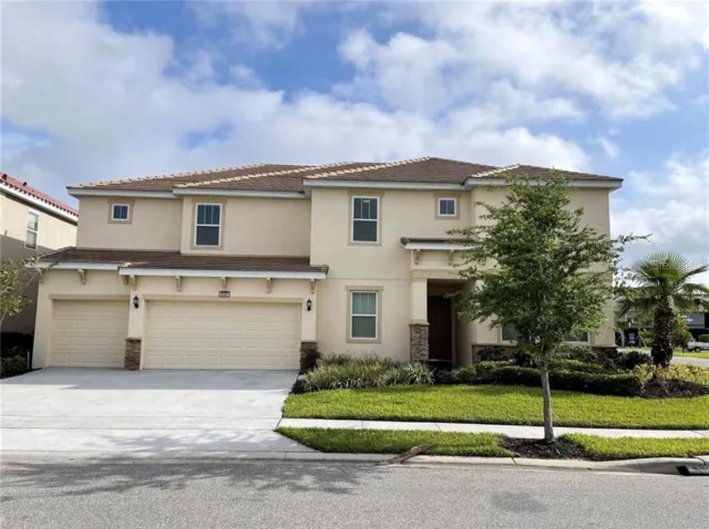 Restricted Address Davenport, FL 33837 - Photo 1 of 33 a view of a white house with a yard and a car parked