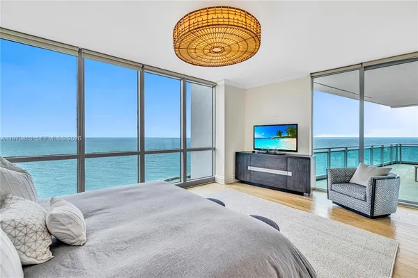 a bedroom with a bed and a view of balcony