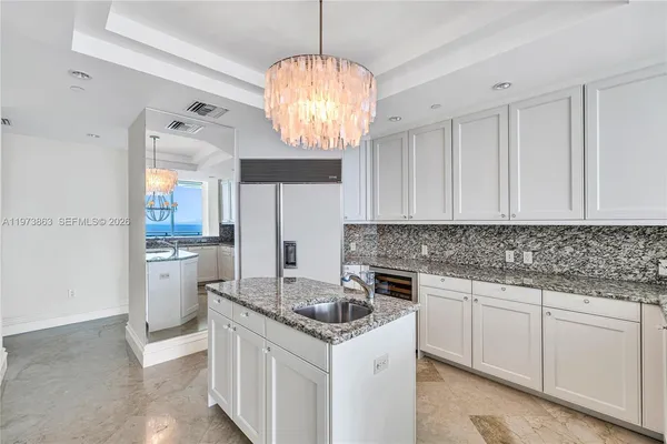 a kitchen with a stove a sink and a refrigerator
