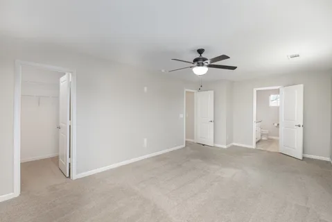 a view of an empty room with a ceiling fan