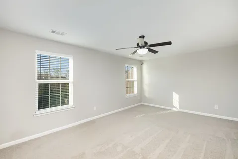 a view of a livingroom with a ceiling fan and window