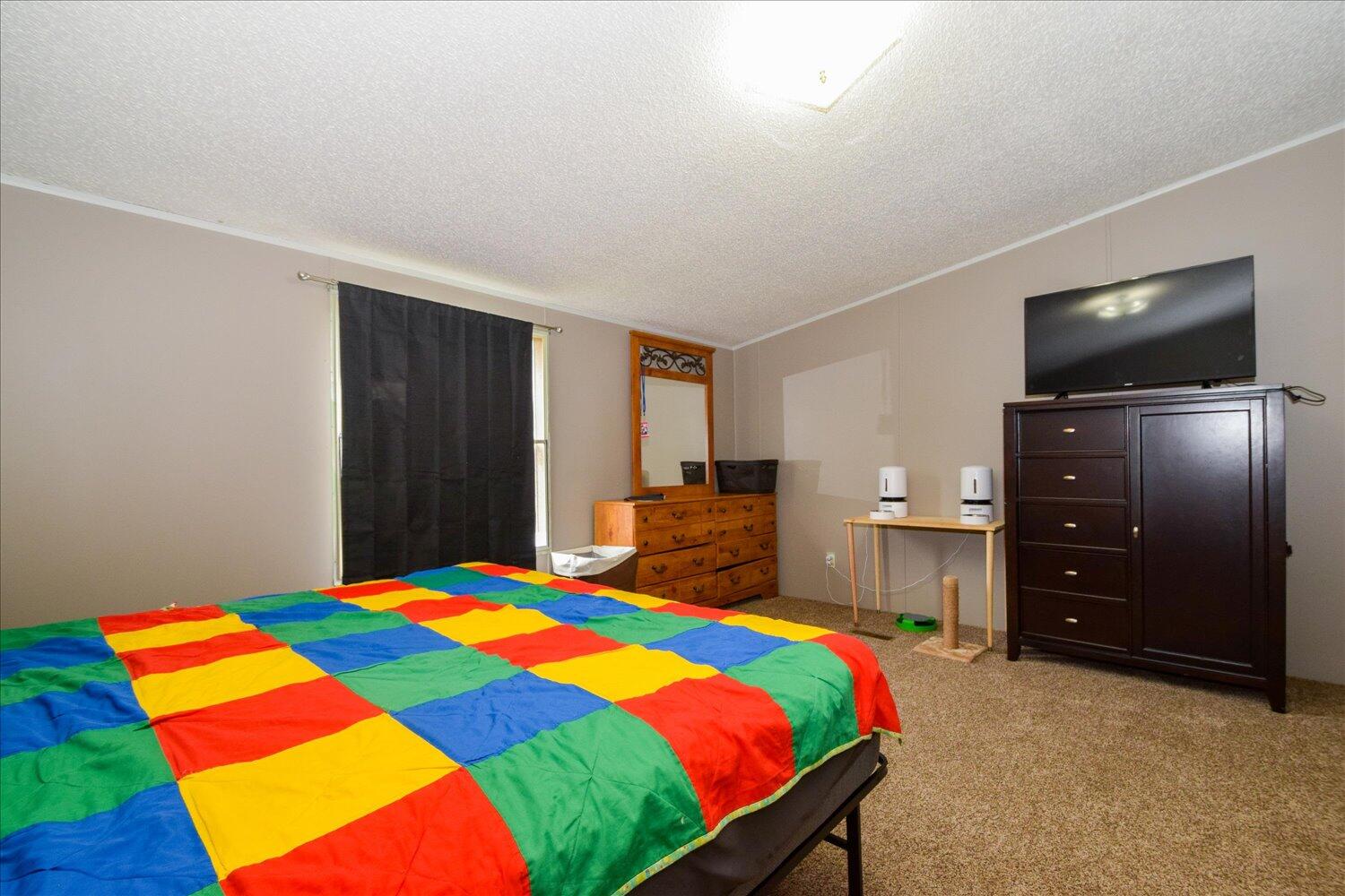 6423 Meacham Road Salem, VA 24153 - Photo 13 of 29 a bedroom with a bed and a flat screen tv
