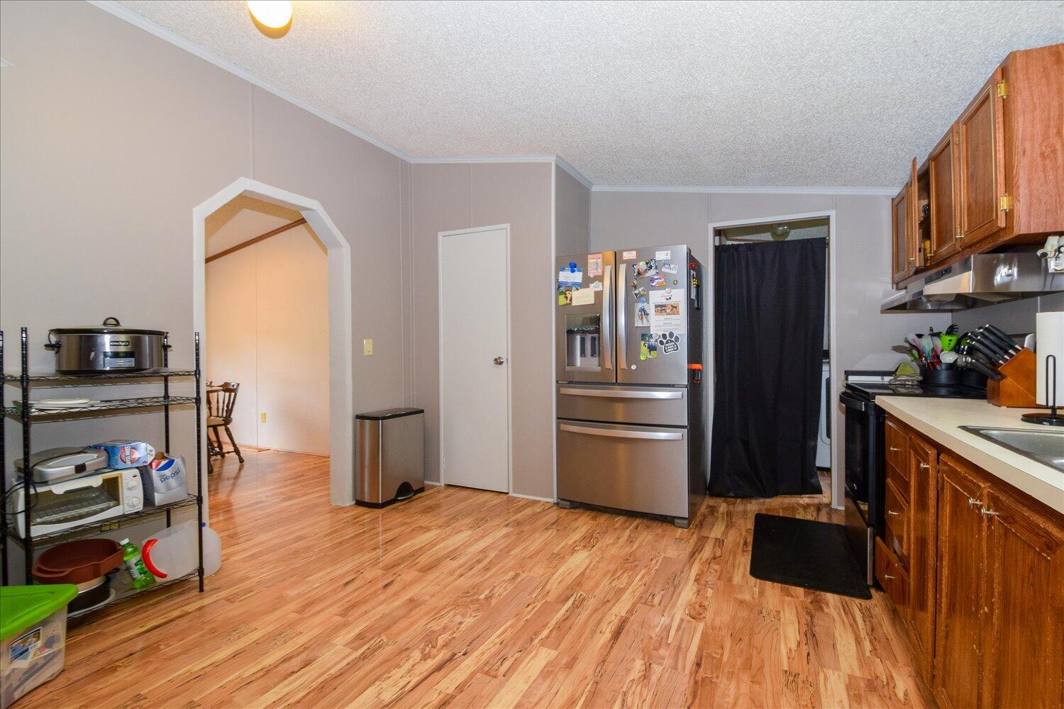 6423 Meacham Road Salem, VA 24153 - Photo 8 of 29 a kitchen with stainless steel appliances a refrigerator and a wooden floor