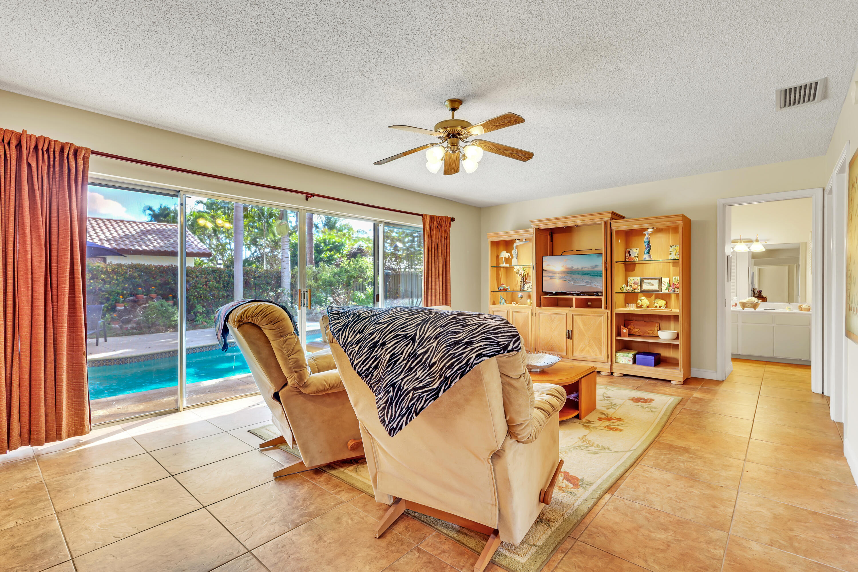 1440 Southwest 20th Street Boca Raton, FL 33486 - Photo 19 of 45 a living room with furniture and a flat screen tv