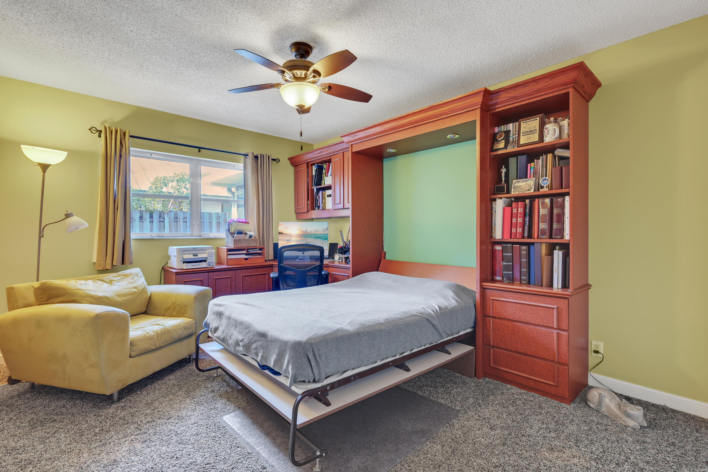 1440 Southwest 20th Street Boca Raton, FL 33486 - Photo 25 of 45 a bedroom with a bed and a chandelier