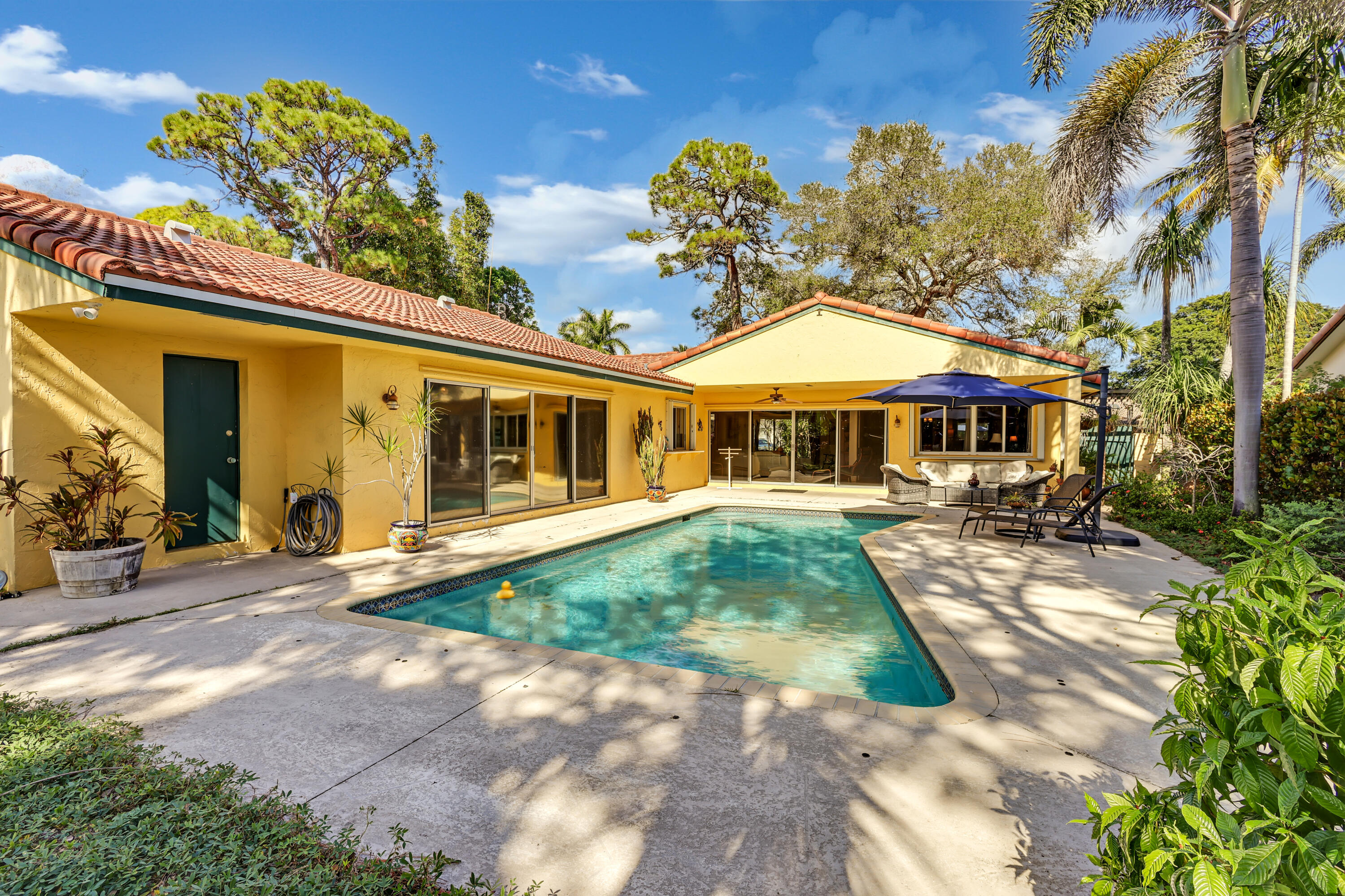 1440 Southwest 20th Street Boca Raton, FL 33486 - Photo 30 of 45 a front view of a house with garden