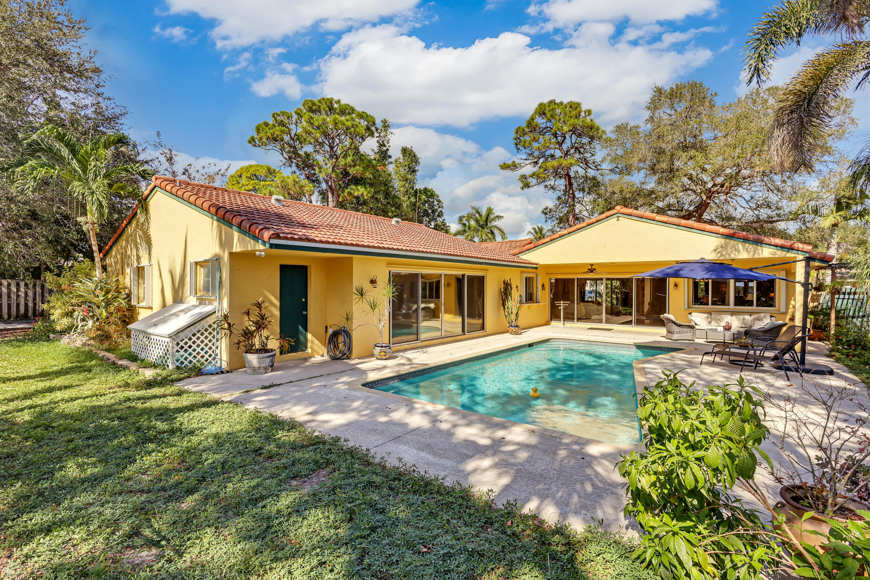 1440 Southwest 20th Street Boca Raton, FL 33486 - Photo 36 of 45 a front view of a house with garden