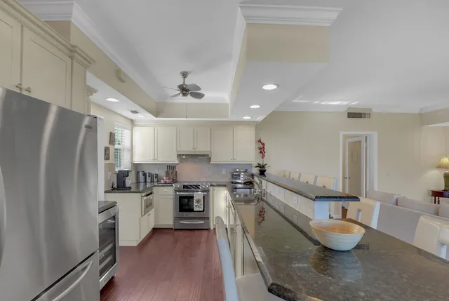 a kitchen with stainless steel appliances granite countertop a sink stove and refrigerator