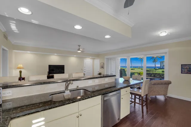 a large white kitchen with a large window
