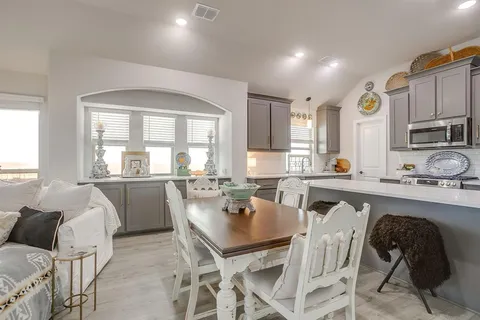 a view of a dining room with furniture and a window