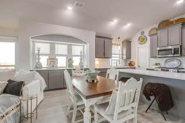 a view of a dining room with furniture and a window