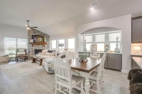 a living room with fireplace furniture and a large window