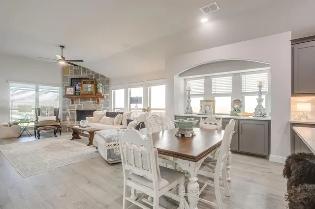 a living room with fireplace furniture and a large window