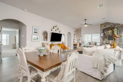 a living room with fireplace furniture and a flat screen tv