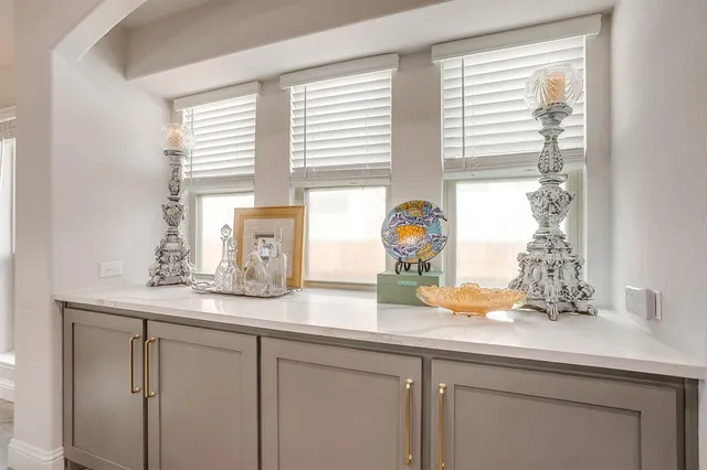 a bathroom with a granite countertop sink and a window