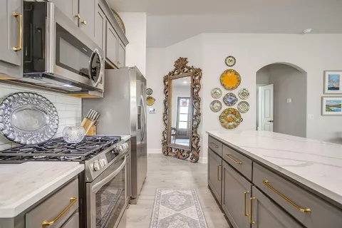 a kitchen with stainless steel appliances granite countertop a stove and a sink