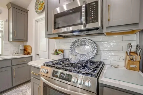 a stove top oven sitting inside of a kitchen