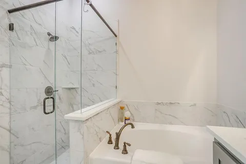 a bathroom with a bathtub and shower