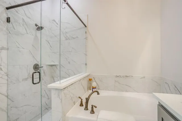 a bathroom with a bathtub and shower