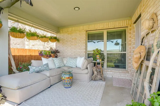 a balcony with furniture and a potted plant