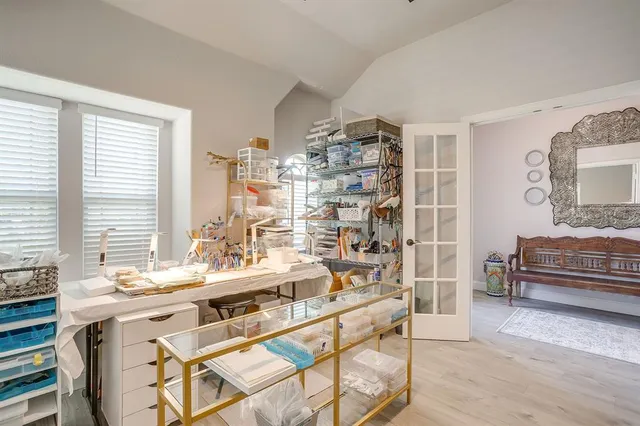 a room with stainless steel appliances kitchen island granite countertop a sink and a wooden cabinets