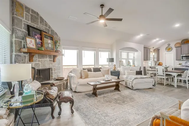 a living room with fireplace furniture and a chandelier