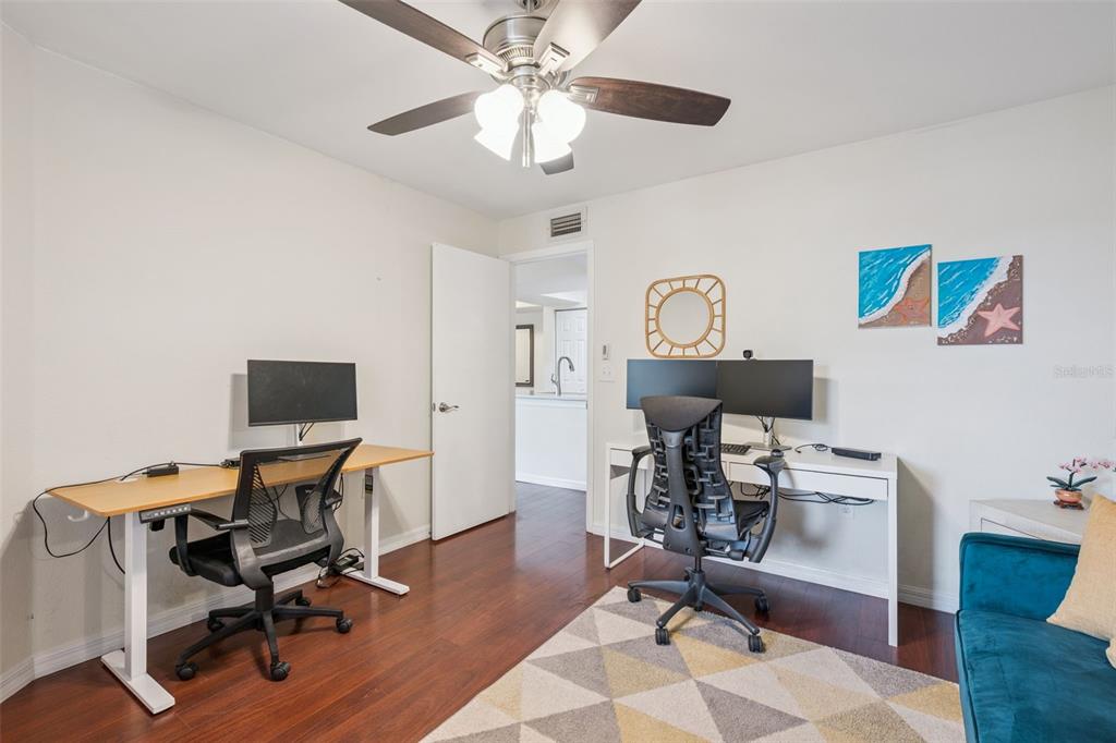 3032 Parkway Boulevard, Unit 305 Kissimmee, FL 34747 - Photo 12 of 40 a view of a workspace with furniture and a fan