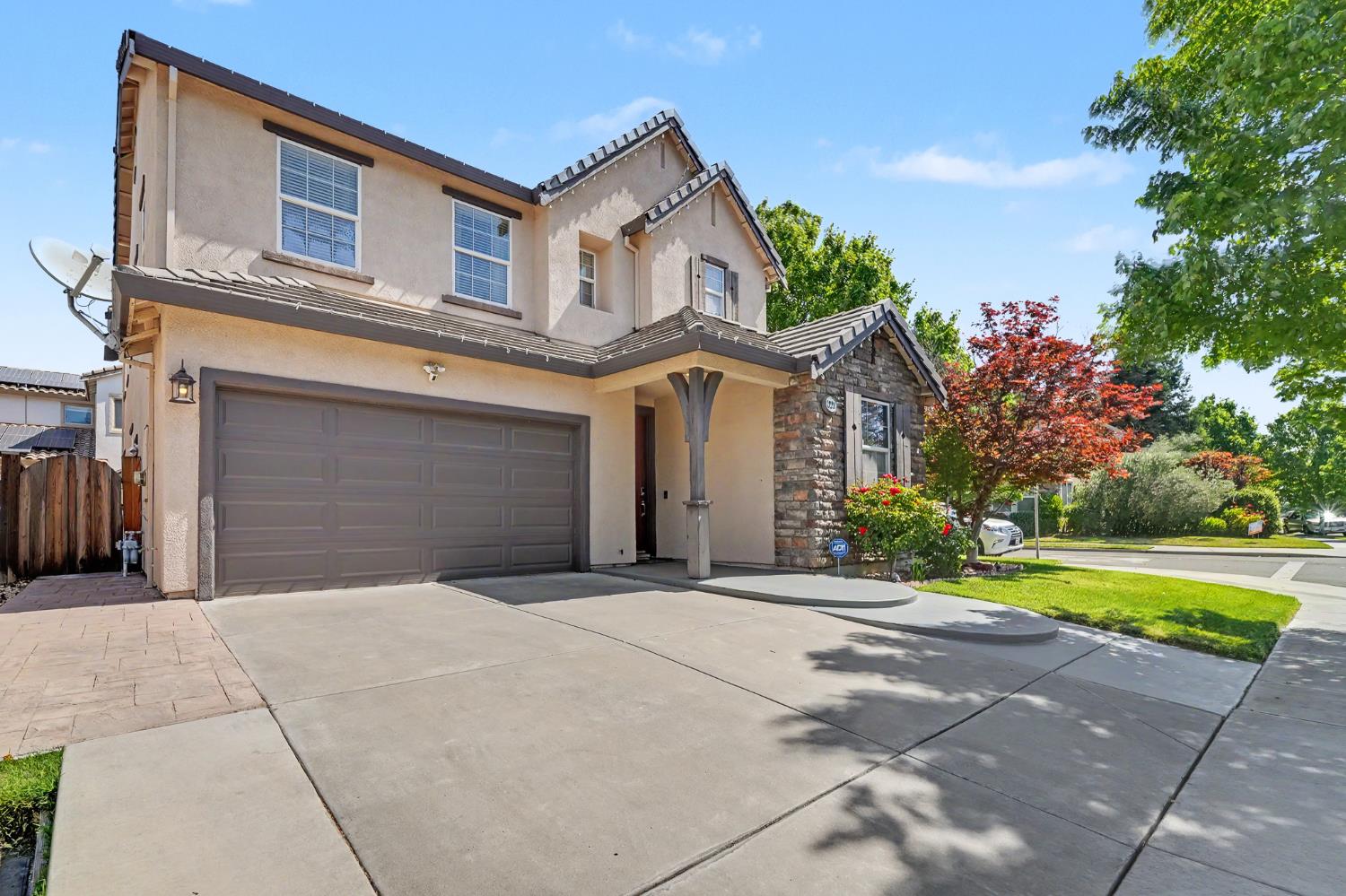 1223 East Springer Drive Turlock, CA 95382 - Photo 2 of 48 a front view of a house with a yard and garage