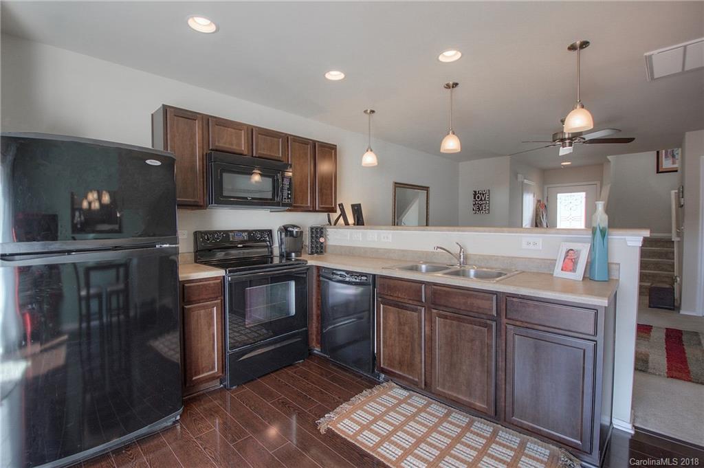 311 River Clay Road Fort Mill, SC 29708 - Photo 5 of 26 a kitchen with stainless steel appliances granite countertop a stove a sink and a microwave