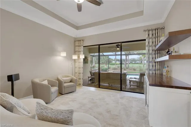 a living room with furniture and a floor to ceiling window