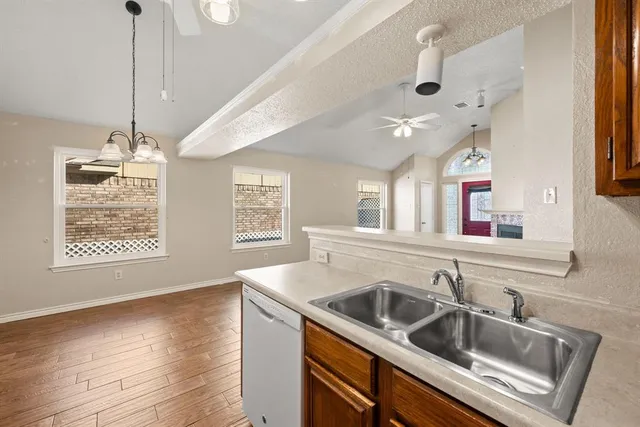 a kitchen with a sink a counter space and a window