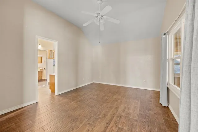 wooden floor in an empty room with a window