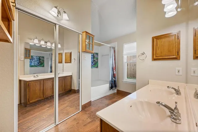 a bathroom with a sink a mirror and a bathtub