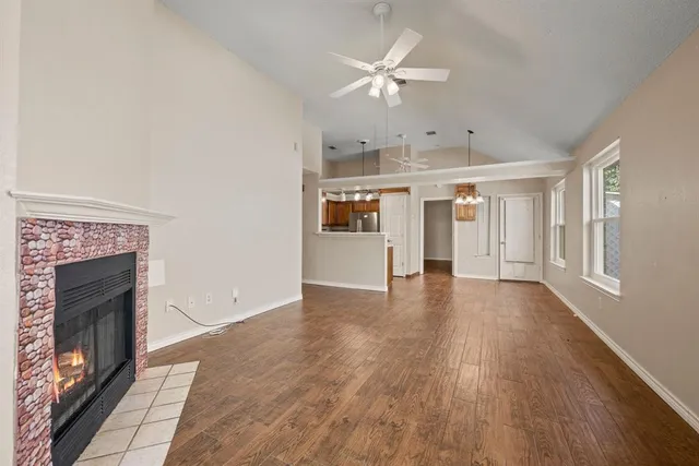 wooden floor in an empty room with a fireplace