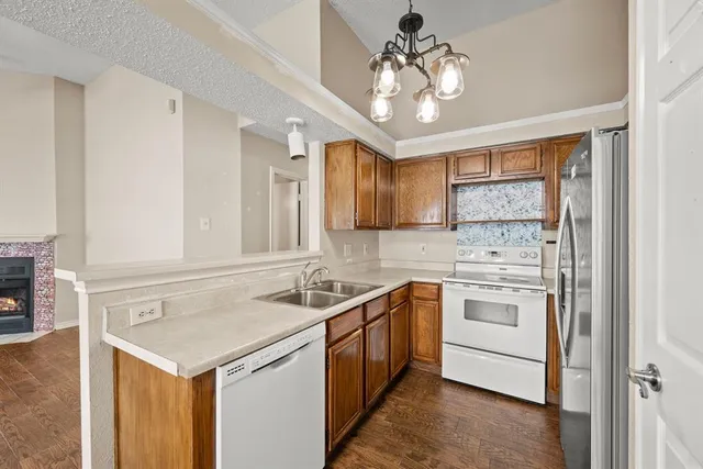 a kitchen with a stove sink and cabinets
