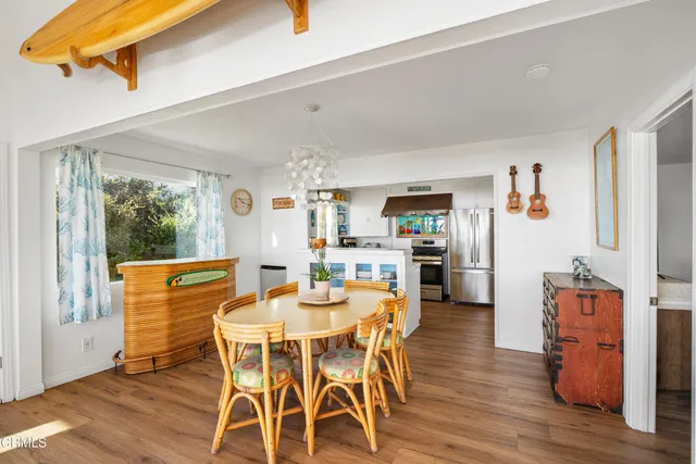 a dining room with furniture and wooden floor